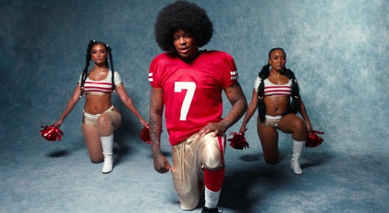 YG releases "Swag" music video, where he pays homage to Colin Kaepernick, rocking the afro, and taking the knee to kneel.