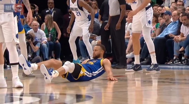 Stephen Curry laughs after Luka Doncic slams him to the ground