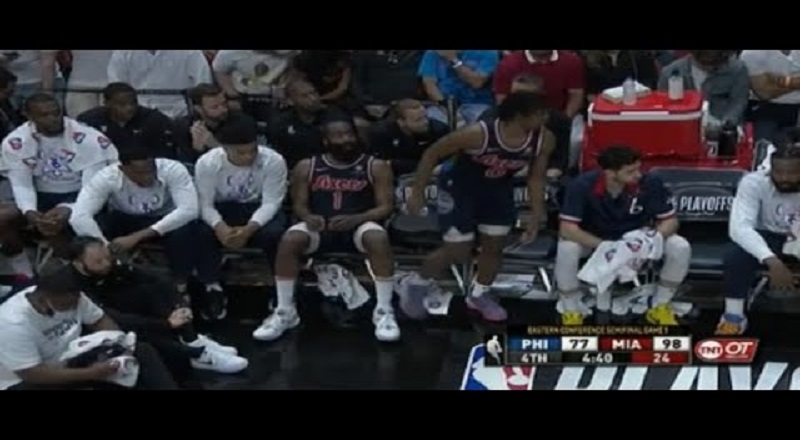 Tyler Maxey moves when James Harden sits beside him on the bench