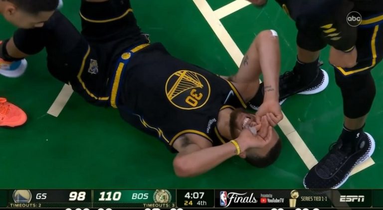 Stephen Curry cries after Al Horford lands on the back of his knee