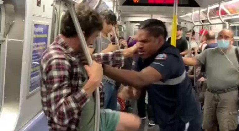 White man fights Black man on a moving train
