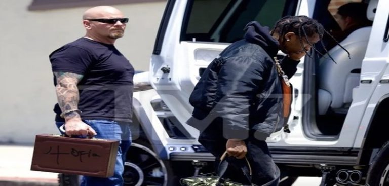 Travis Scott's security guard wears handcuffed "Utopia" briefcase