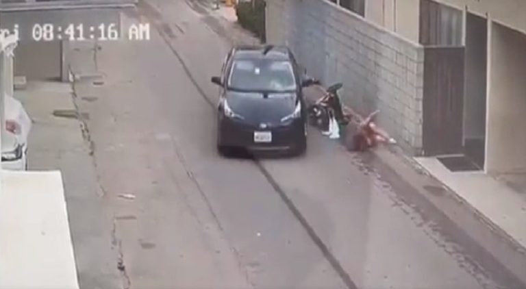 Woman jumps in front of moving van to save her infant child