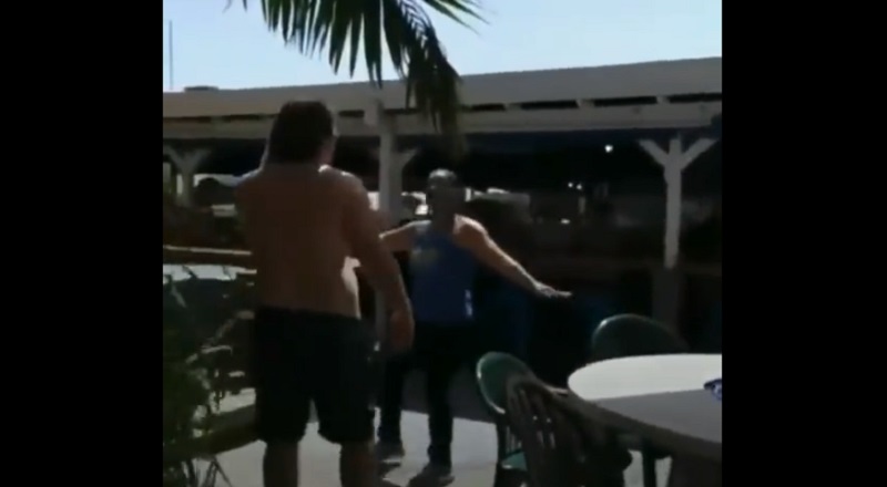 Shirtless man smacks woman on the head and gets tackled