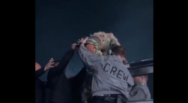 Guard touches Beyonce's back side helping her get out of tank