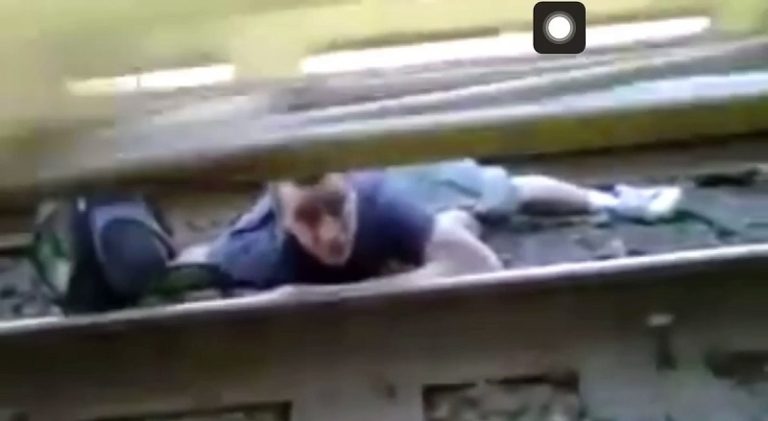 Man barely survives getting stuck under moving train
