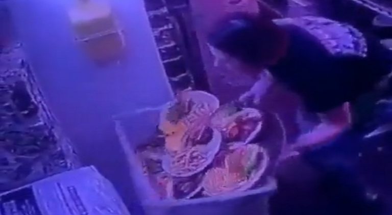 Restaurant worker accidentally drops plates of food in trash can