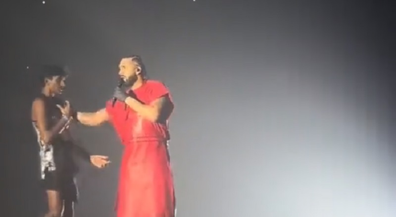 Drake shoves a fan in the chest who walked up on stage