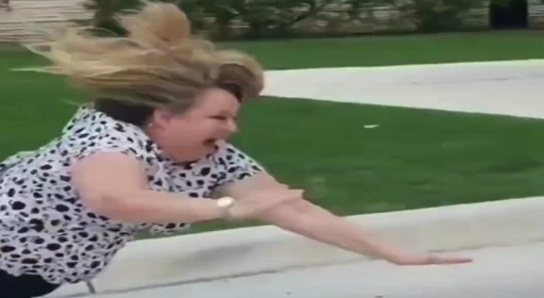 Woman falls on her face after vandalizing a car and running off