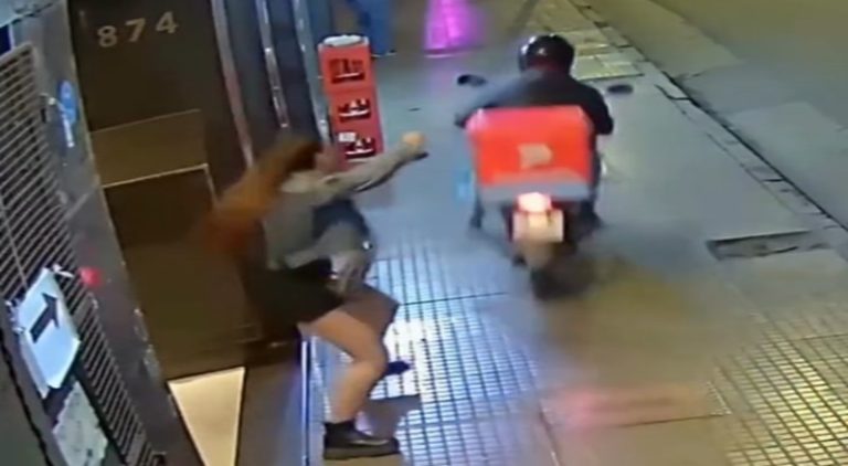 Man rides up to a woman on his moped and steals her phone
