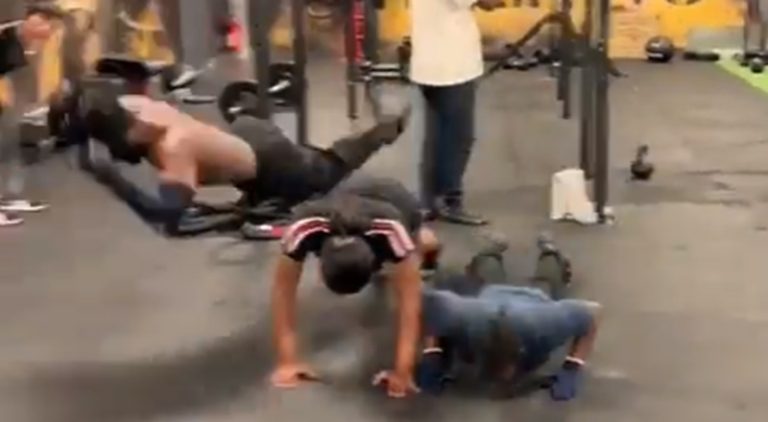 Man starts jumping over people in the middle of his workout
