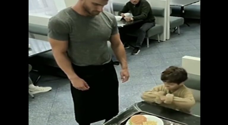 Waiter takes leftover food from child and gives him fresh plate