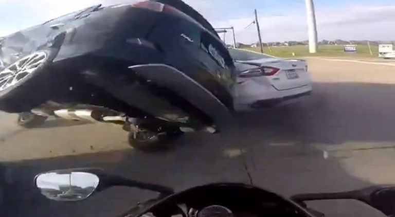 Horrific car crash ends with car almost landing on motorcycle