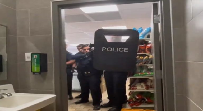 Police arrest a man while he is using the bathroom