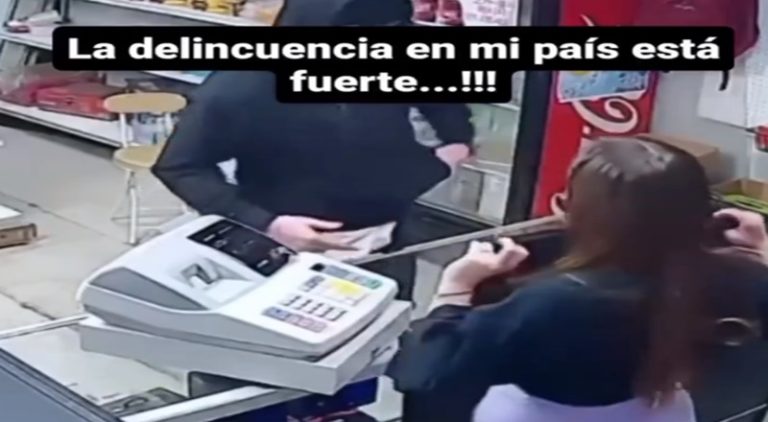 Woman lifts shirt to stop robbery of store she works in