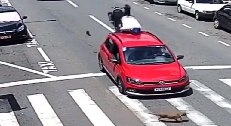 Motorcycle rider rear ends car and his body flips over it