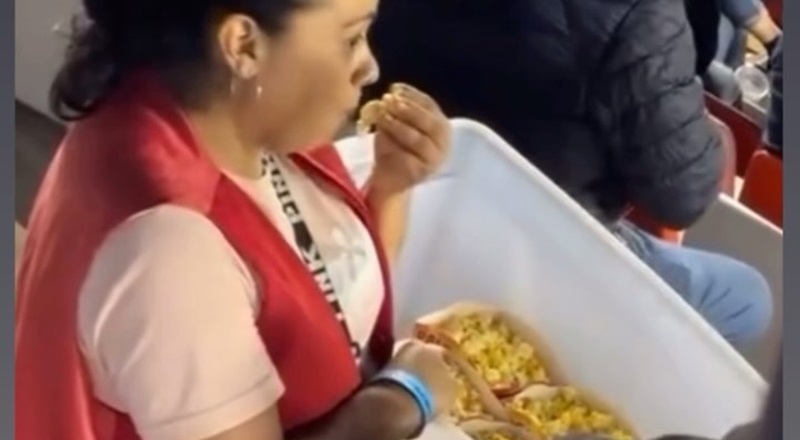 Popcorn vendor eats from buckets that she was selling